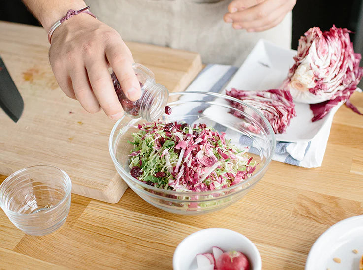 Chef carefully plating a V+B meal